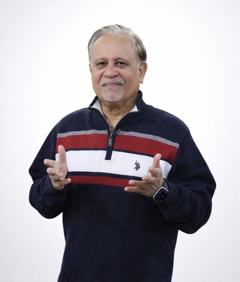 Dr. Moiz Hussain, mind sciences trainer, standing against a plain background